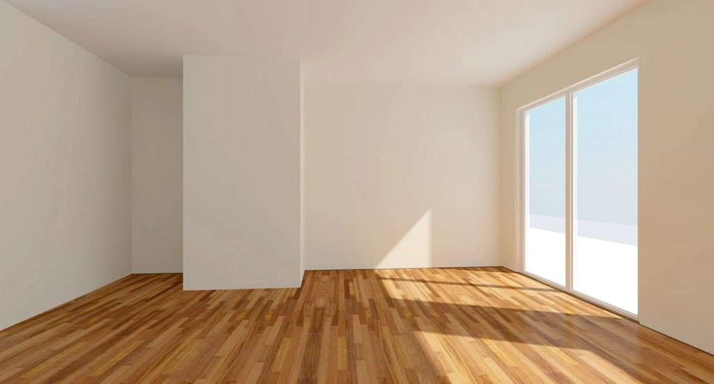 Sala vazia com piso laminado de madeira e janela grande